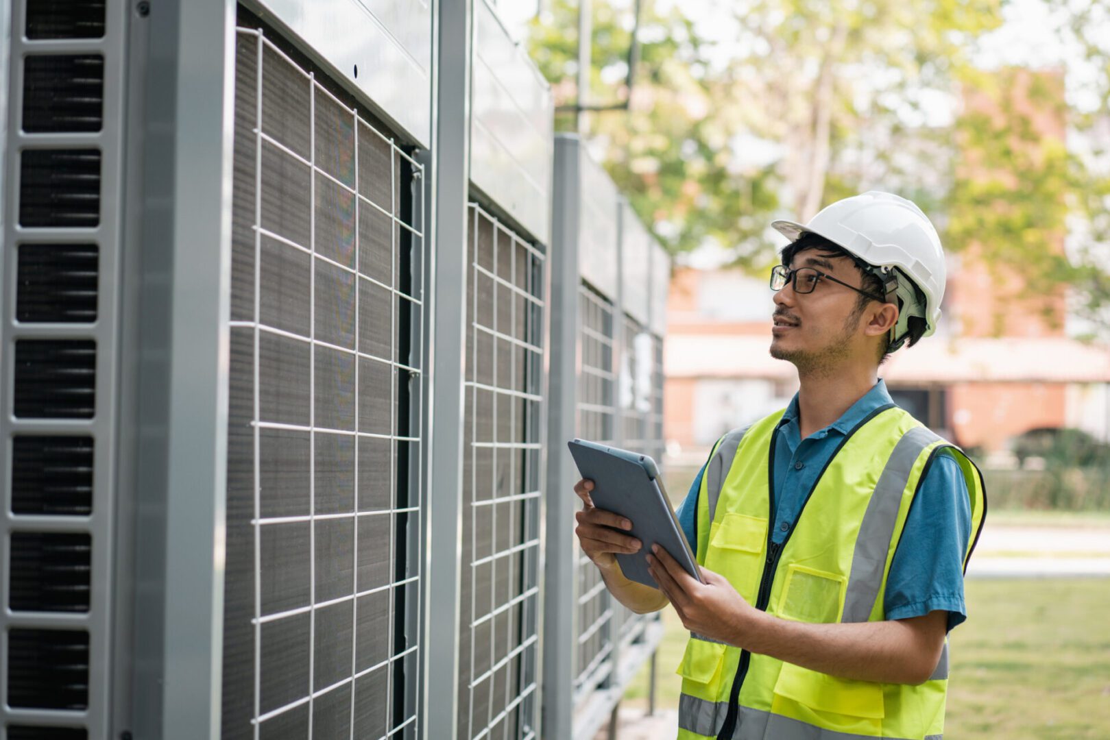 Engineer inspects solar panels with a tablet.